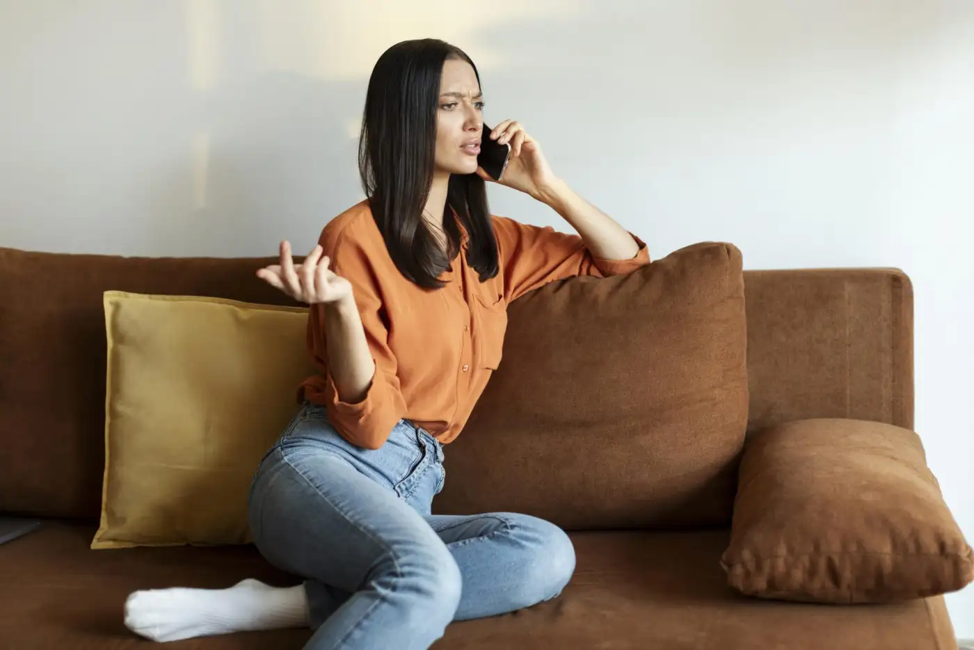 A woman listening on the phone at home