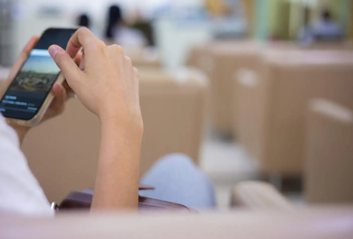 Hands holding a smartphone, waiting for a call