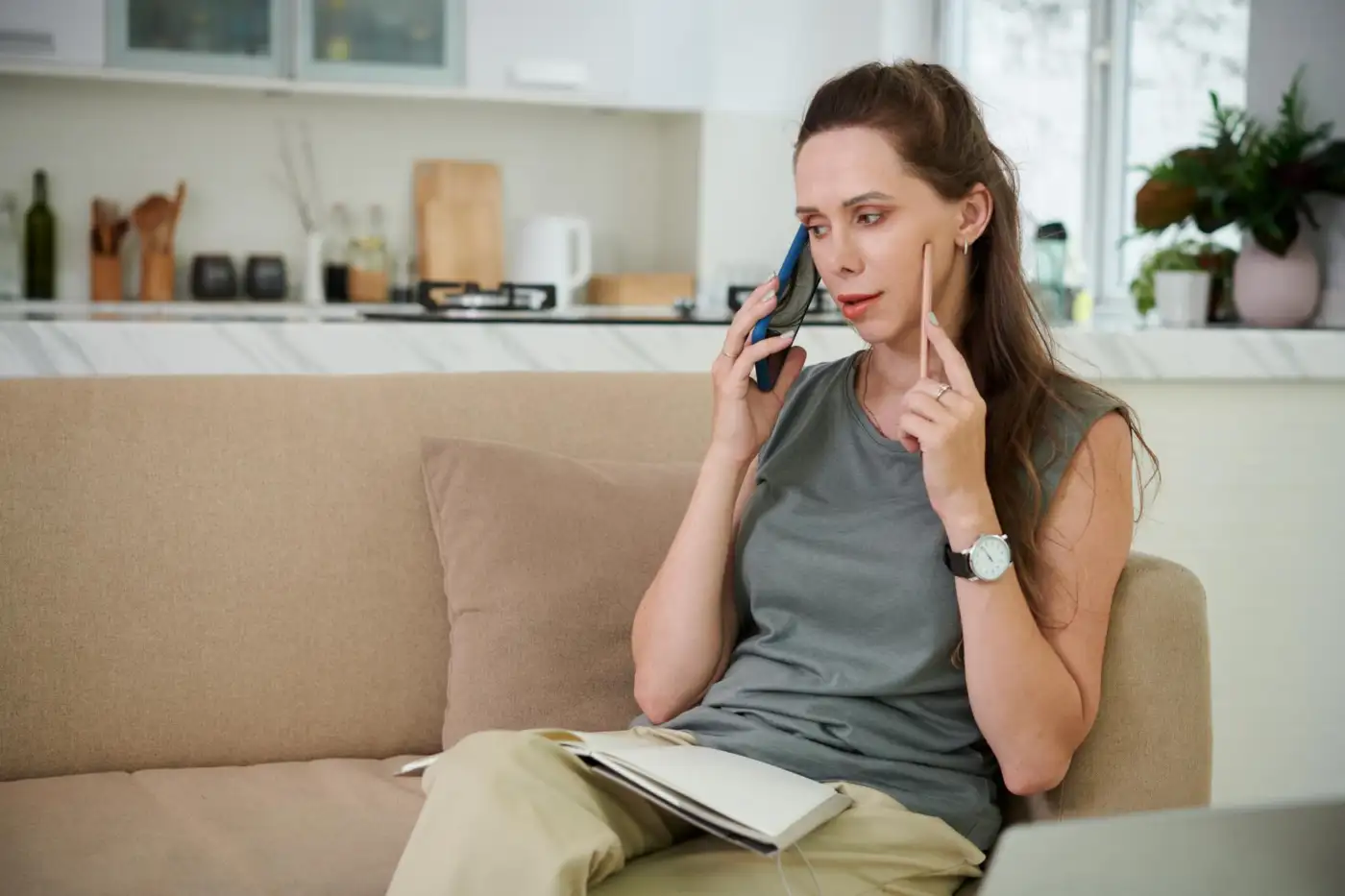 A woman answering her mobile phone at home