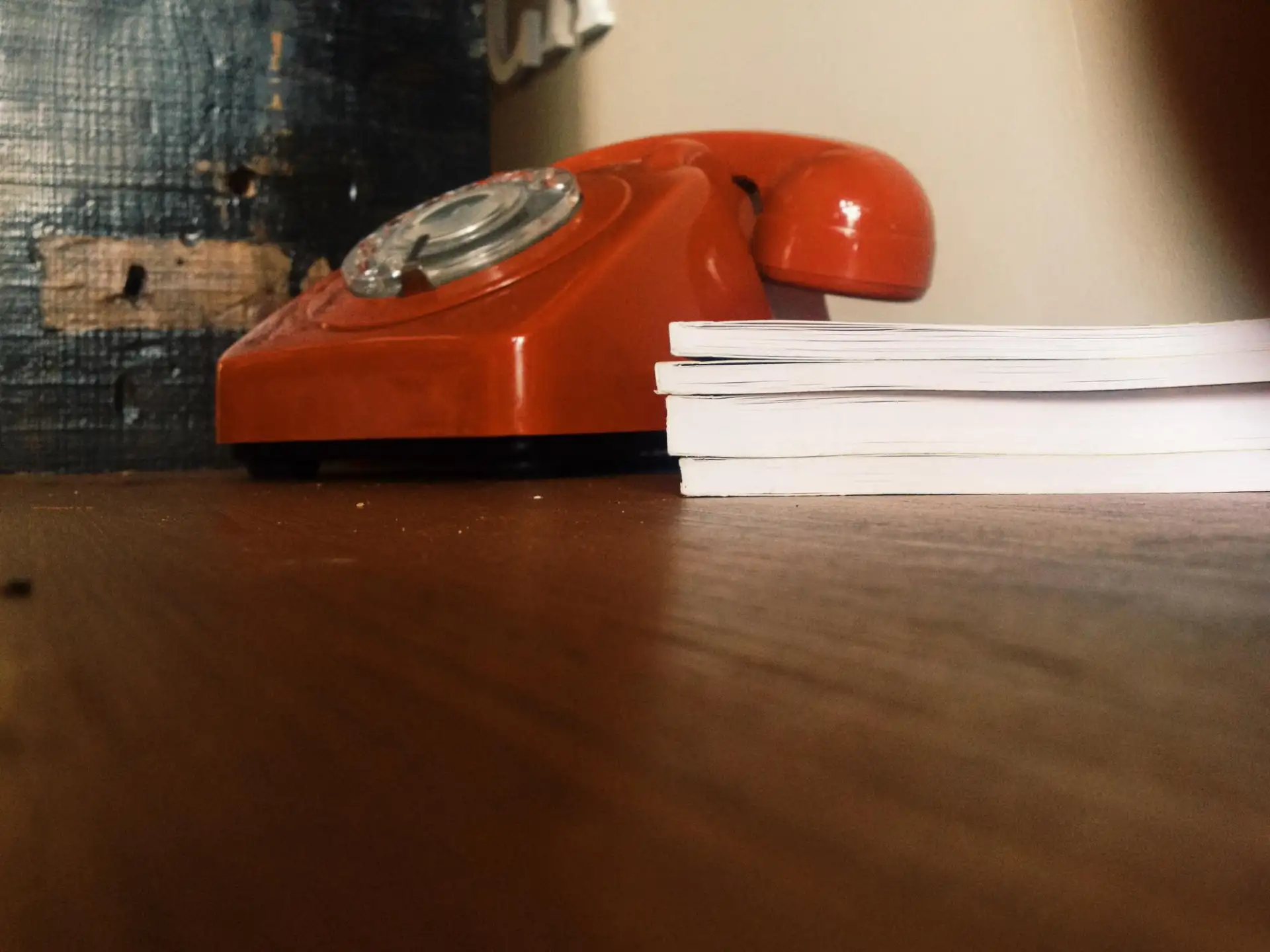 A landline handset resting on a hallway table
