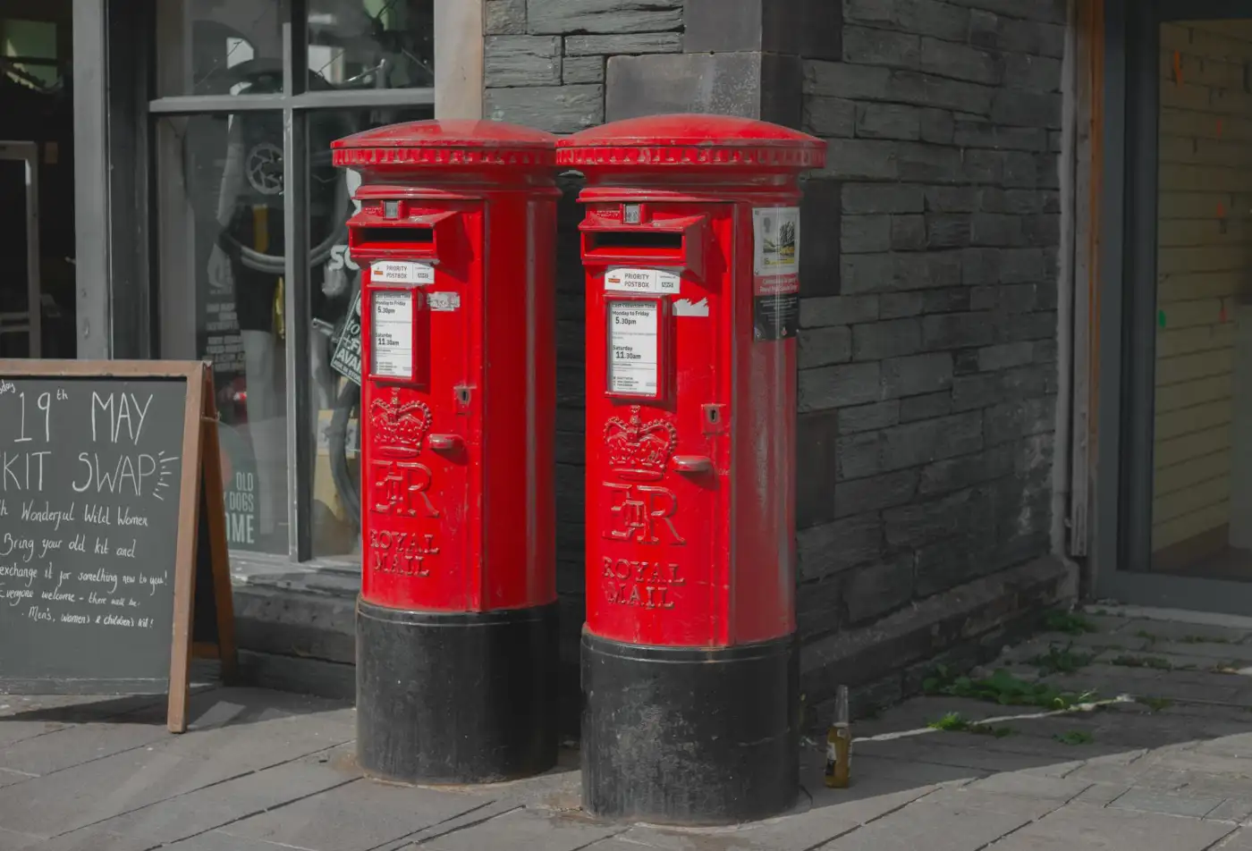 Two red pillar boxes on a British street