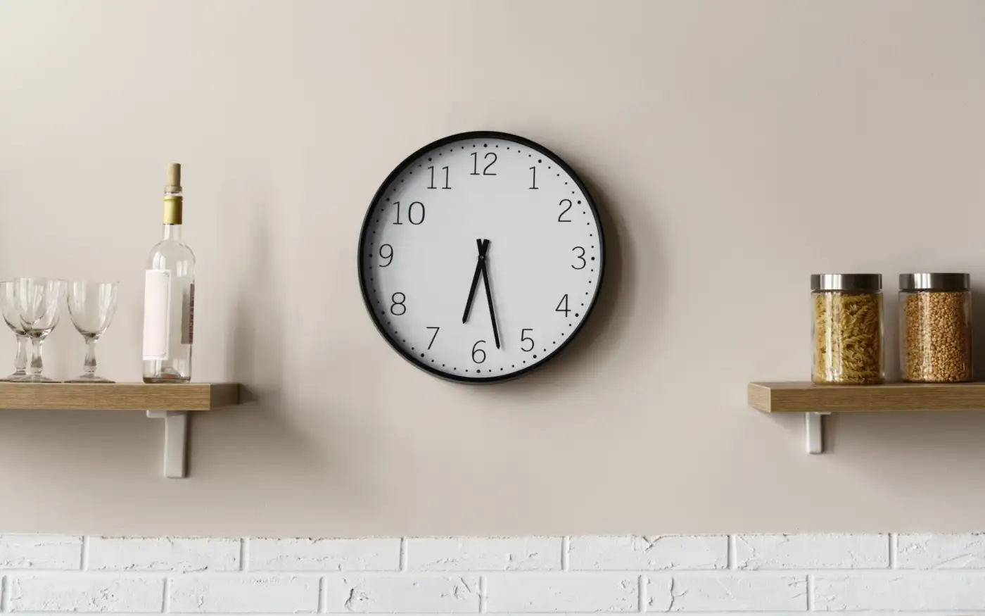 A wall clock in a kitchen