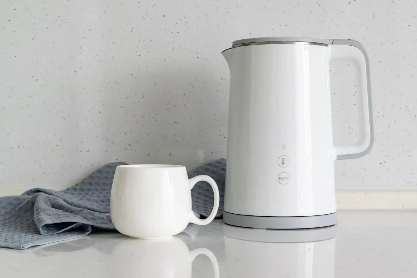 A kettle and a mug on a kitchen worktop