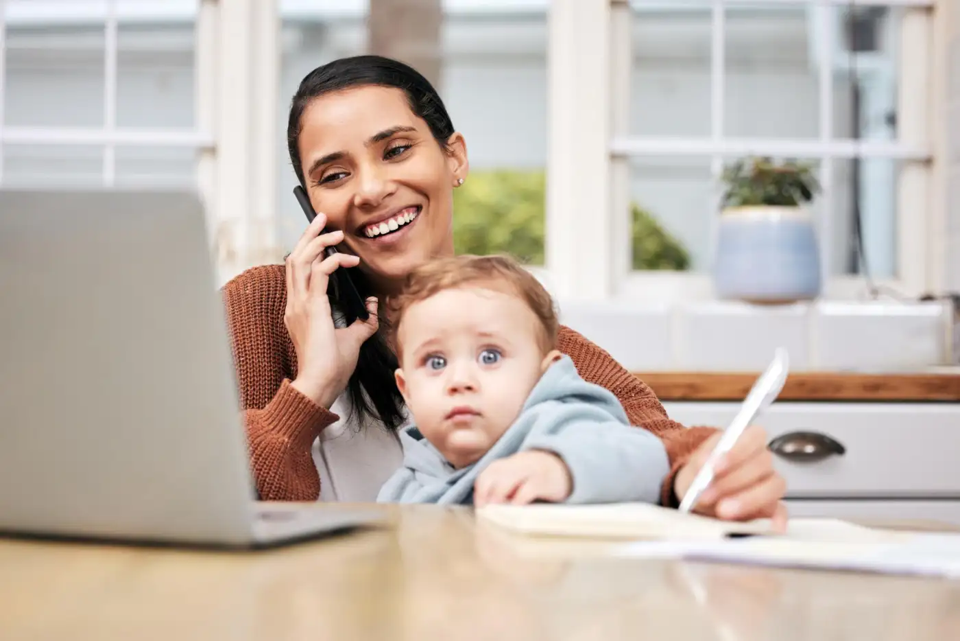 Mother on a phone call with her child at home