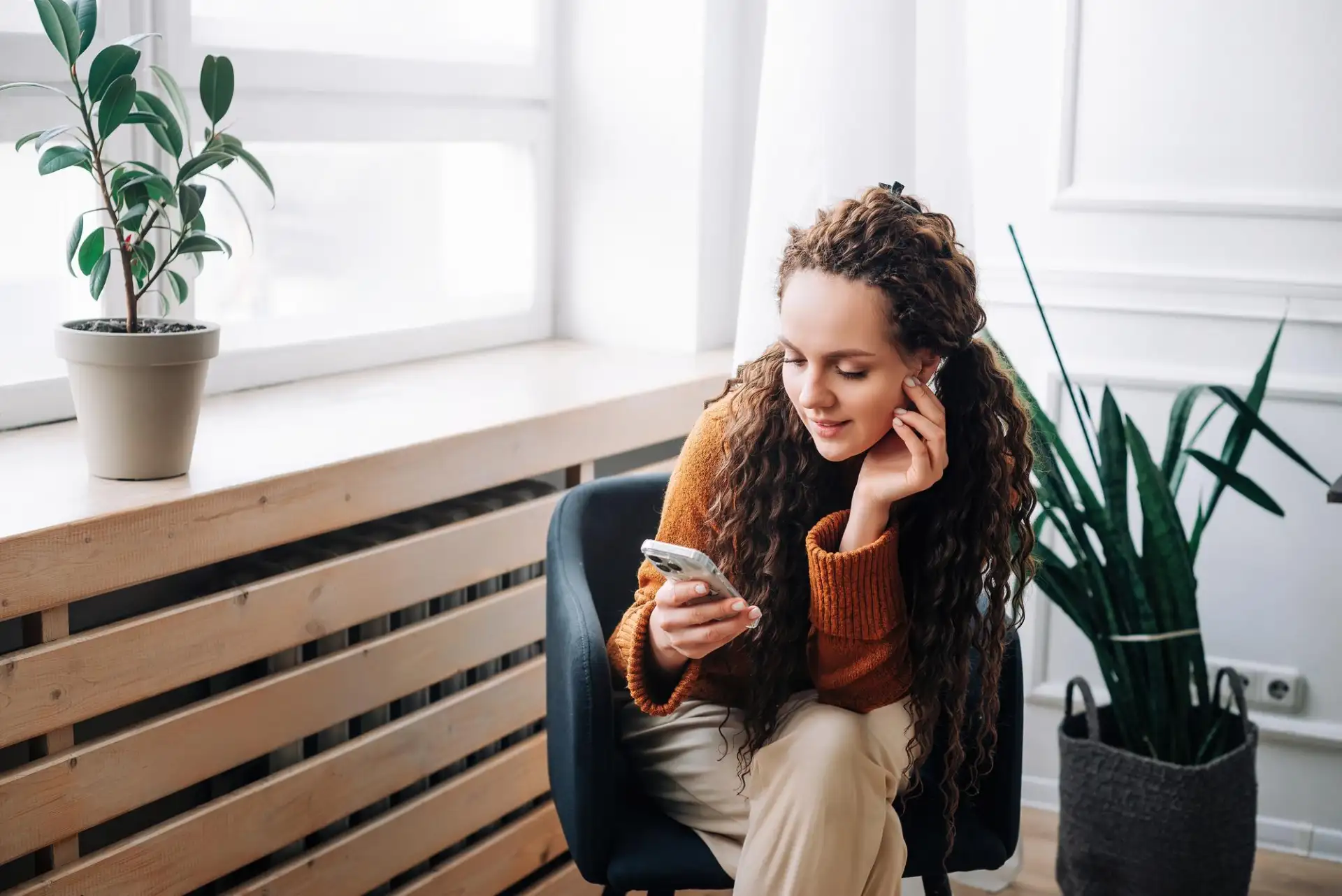 Relaxed woman using a smartphone at home