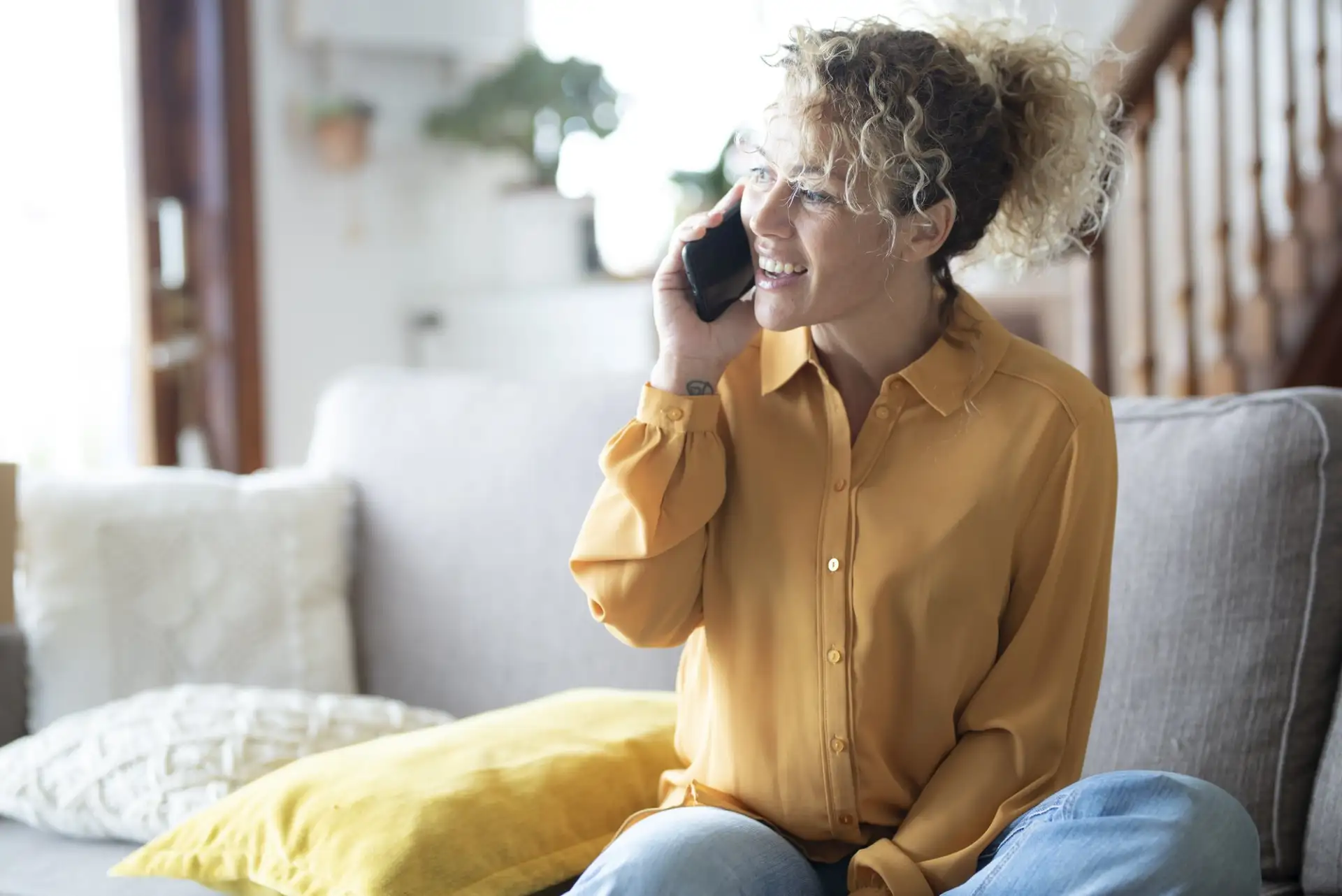 Woman having a serious phone conversation at home